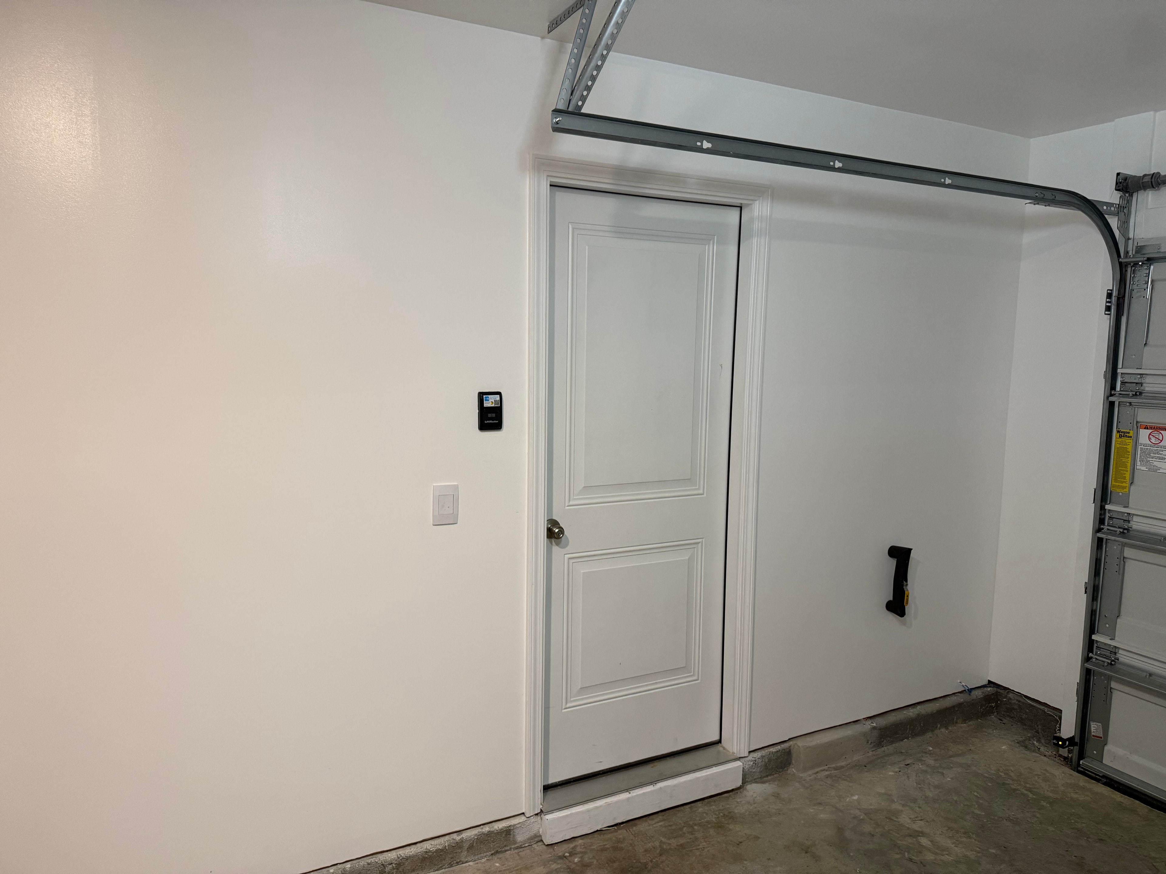 Finished garage interior with clean white walls and painted trim