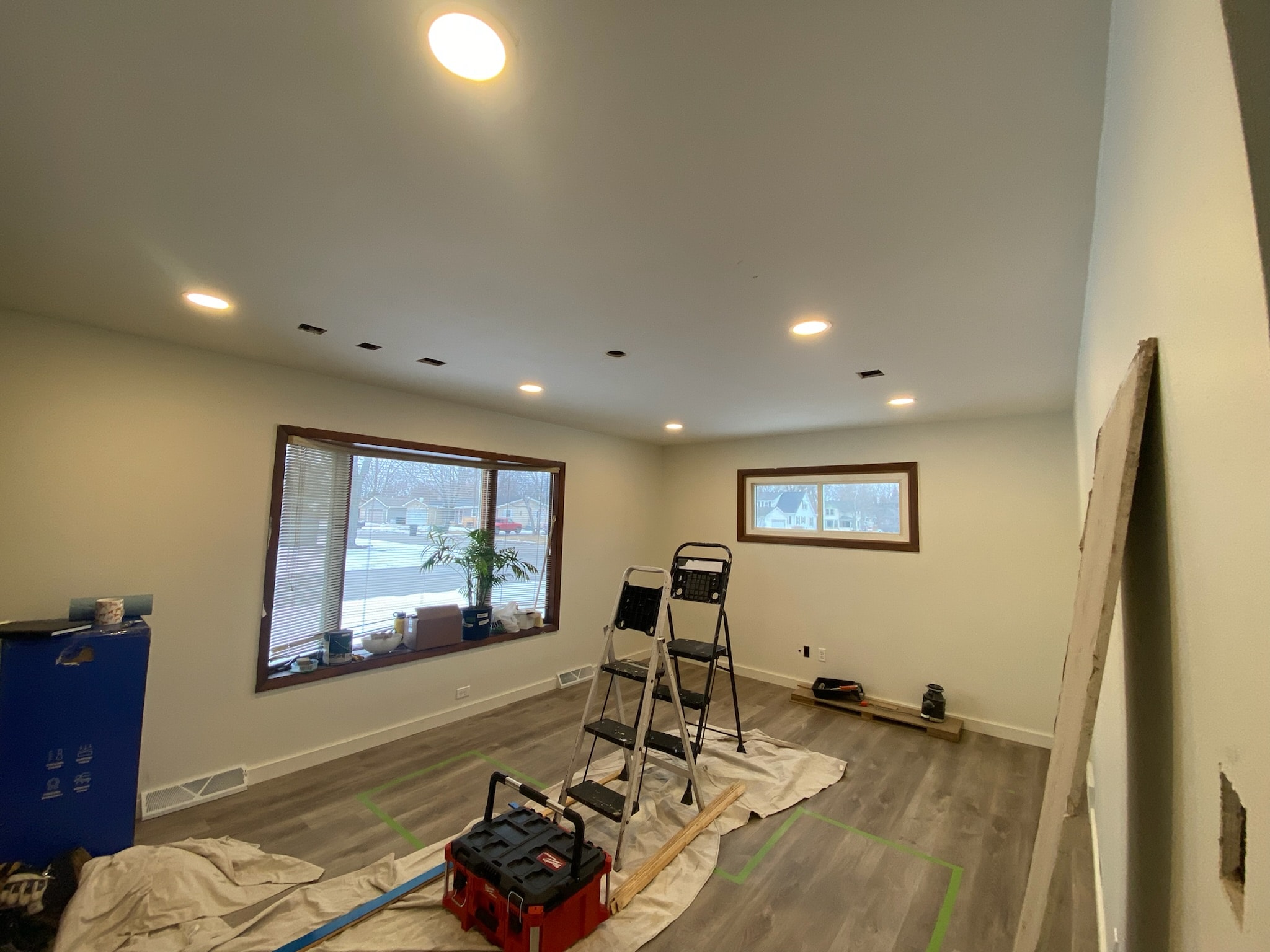 Ceiling patches in progress with ladder and tools visible
